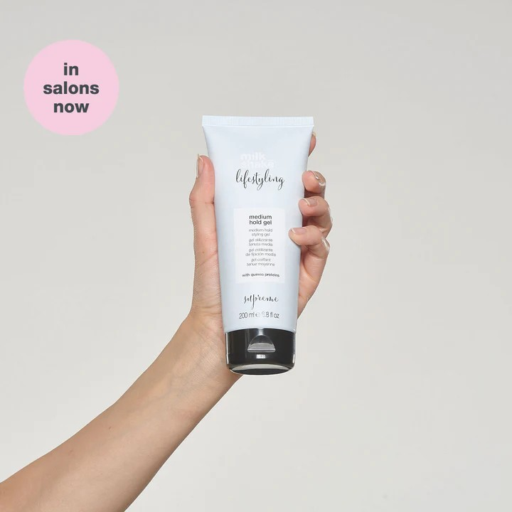 Milk_Shake Lifestyling Medium Hold Gel model holding bottle