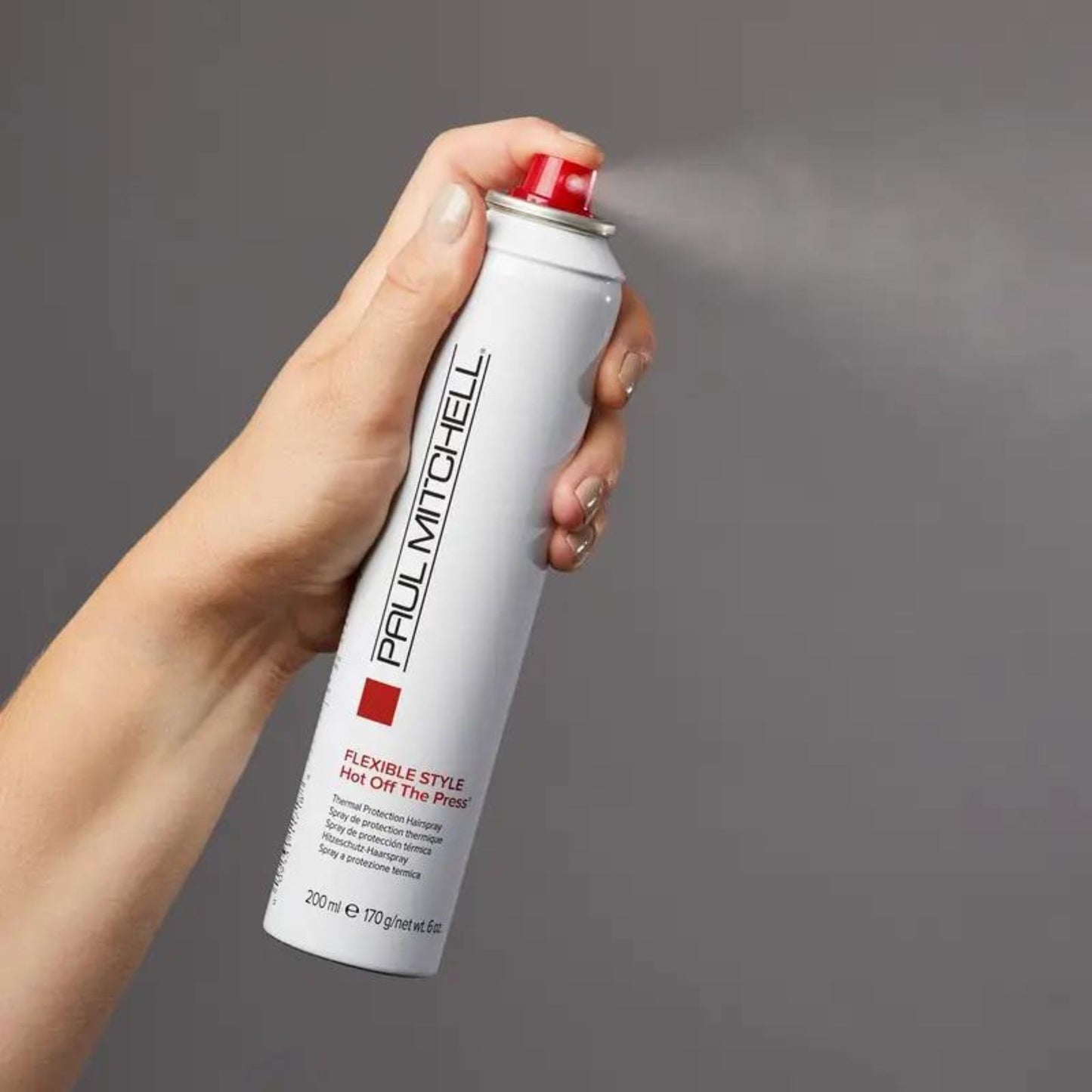 Hot Off The Press Thermal Protection Hairspray - Salon Blissful - Paul Mitchell - model spraying bottle