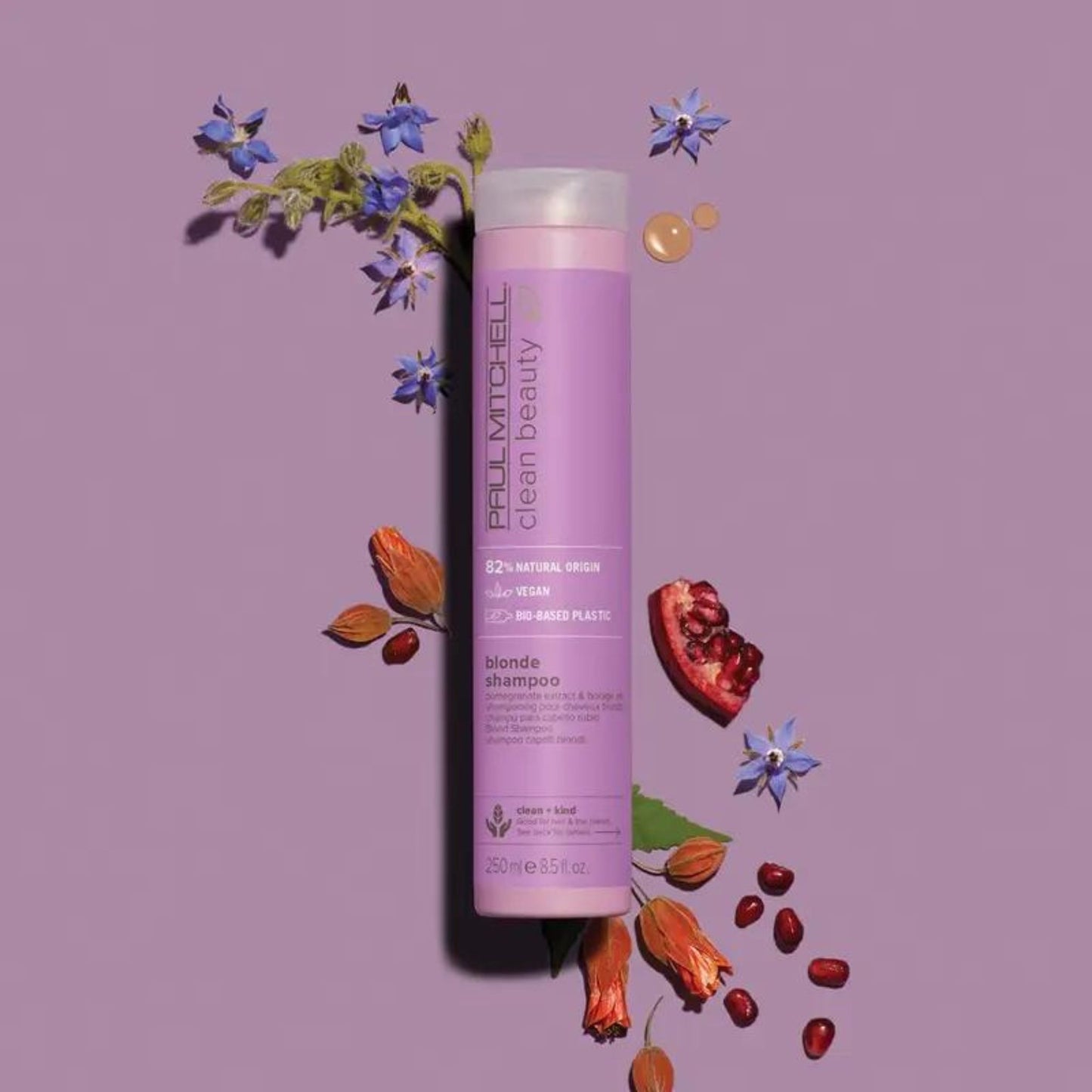 Clean Beauty Blonde Shampoo - Salon Blissful - Paul Mitchell  -  product flat lay with flowers and fruit on purple background