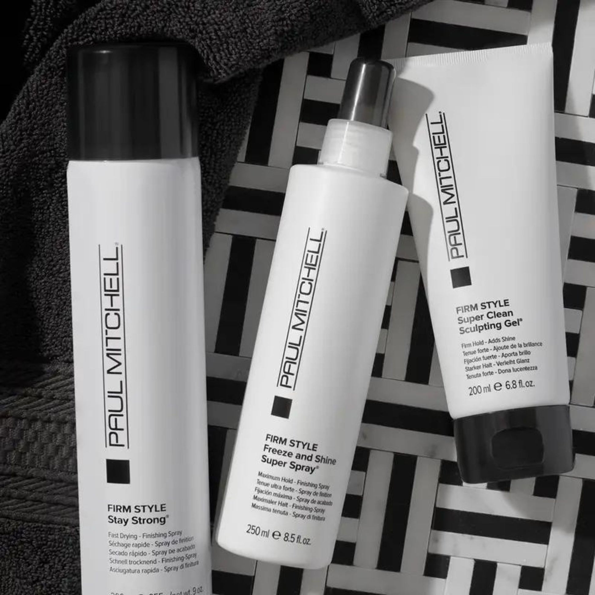 Freeze and Shine Super Spray - Salon Blissful - Paul Mitchell - flat lay of Super Clean product line on white and black background