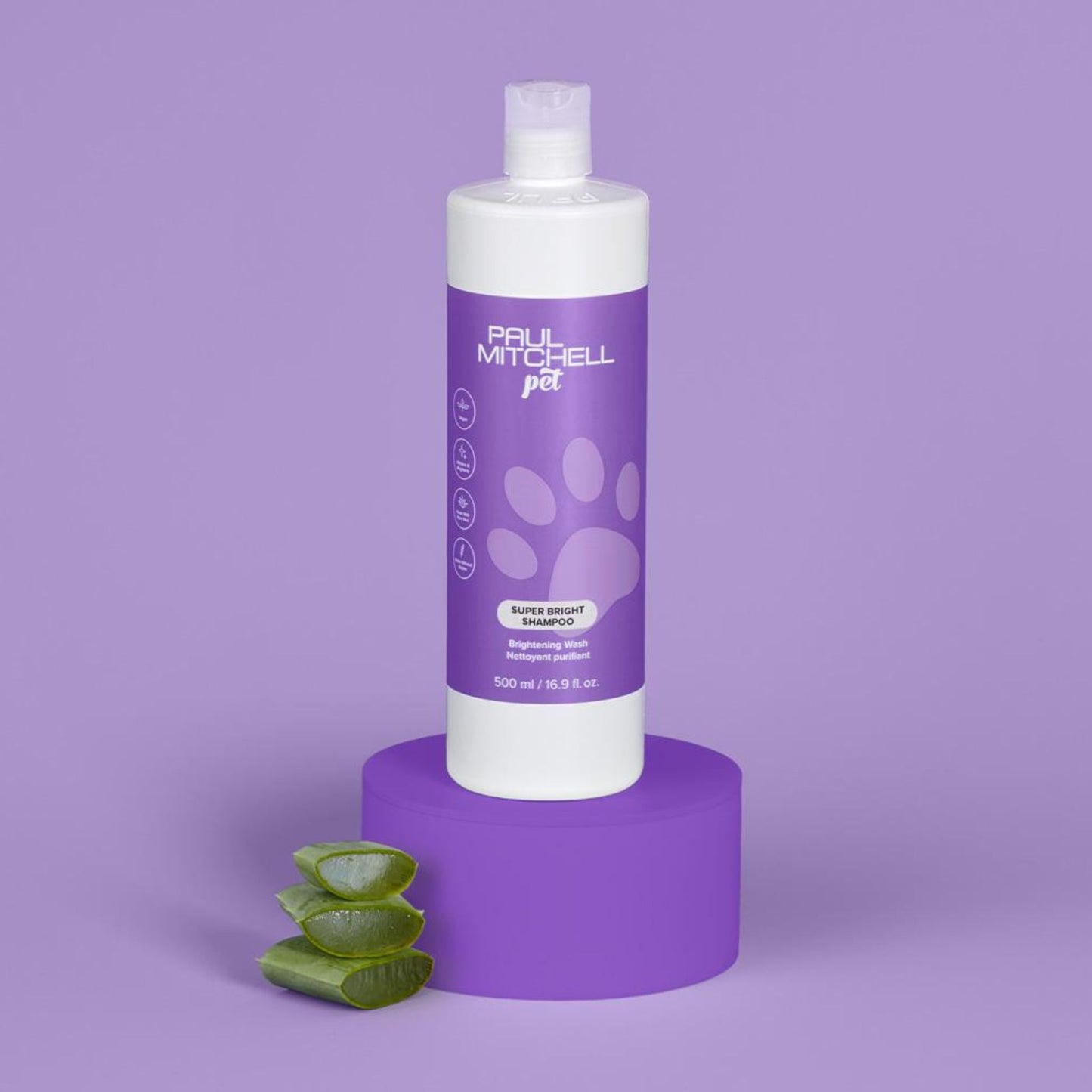 Super Bright Shampoo (Pet) - Salon Blissful - Paul Mitchell - 16.9 oz bottle displayed on purple stand with aloe and purple background